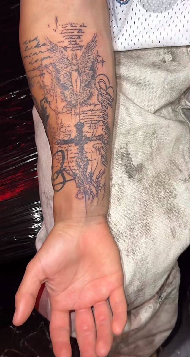 Angel cross and script forearm tattoo